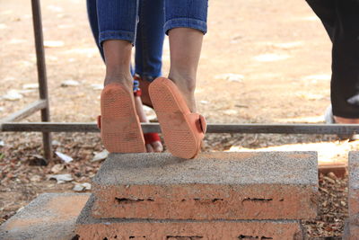 Low section of woman standing on road