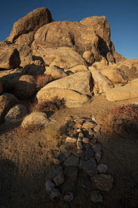 Rock formations on desert land with stone covered grave