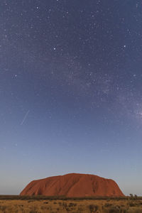 Scenic view of desert against clear sky at night