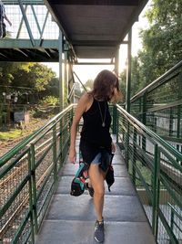 Full length of woman walking on footbridge