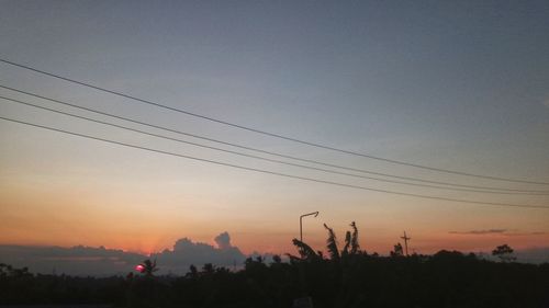 Silhouette trees against sky during sunset