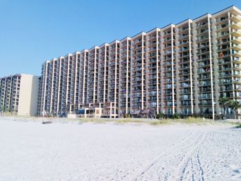 Low angle view of modern building against clear blue sky