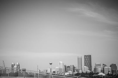 Buildings in city against cloudy sky