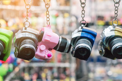 Close-up of camera key rings hanging for sale at market stall
