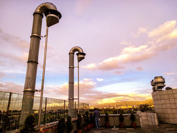 Low angle view of street lights against sky during sunset