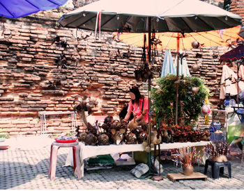 People at market stall building