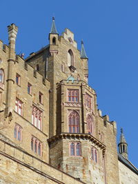 Low angle view of building against clear blue sky