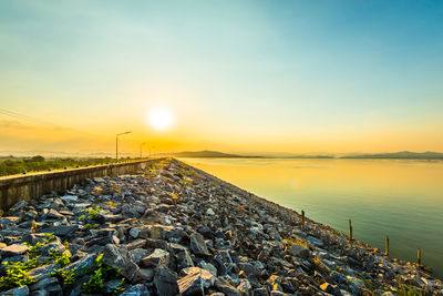 Scenic view of rocks against sky during sunset