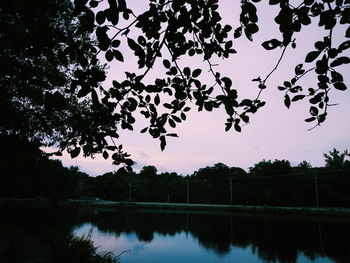 Scenic view of lake against sky at sunset
