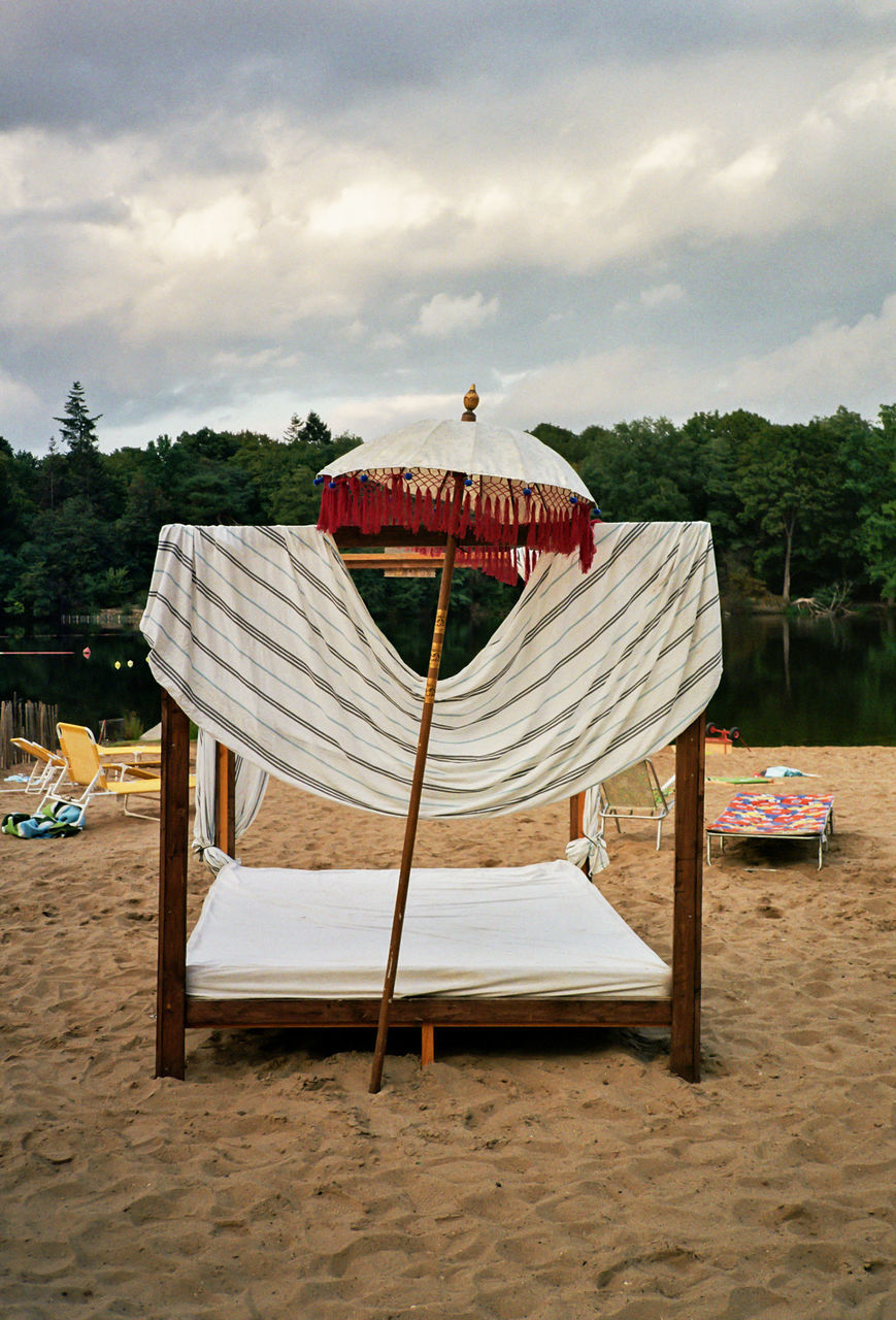 CHAIR ON BEACH AGAINST SKY