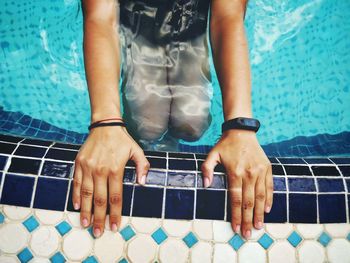 Midsection of man playing with swimming pool