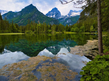 Scenic view of lake and mountains against sky