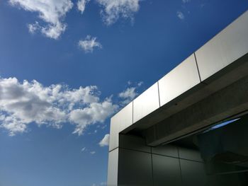 Low angle view of modern building against blue sky