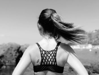 Rear view of young woman with ponytail