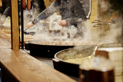 Midsection of man preparing food at street