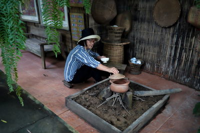 Side view of man working at yard