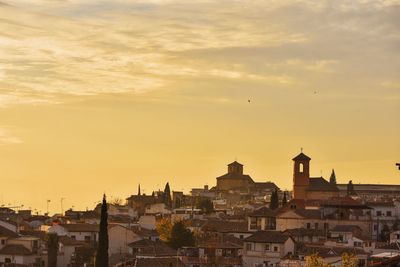 View of cityscape against cloudy sky