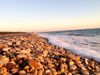 Scenic view of sea against clear sky during sunset