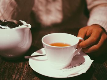 Close-up of hand holding coffee cup