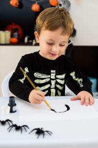 Close-up of boy drawing on table