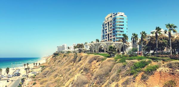 Panoramic view of sea and buildings against clear sky