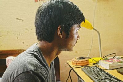 Midsection of man using mobile phone
