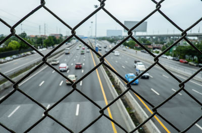 Road seen through chainlink fence
