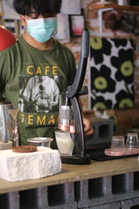 Rear view of man standing at restaurant table