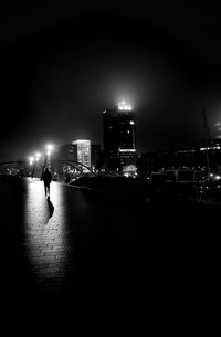 Man in illuminated city at night