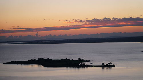 Silhouette boat in sea against sky during sunset