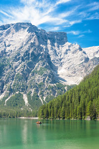 Scenic view of lake by mountains against sky