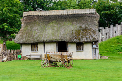 Old barn on field by building