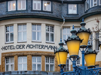 Low angle view of street light against building