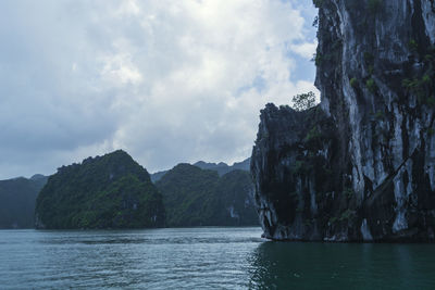 Scenic view of sea and mountains against sky