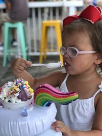 Midsection of girl holding ice cream on table