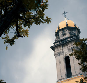 Low angle view of clock tower and building against sky