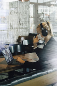 Businesswoman with face mask having video call