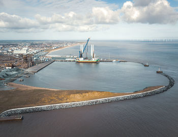 High angle view of harbor by sea against sky