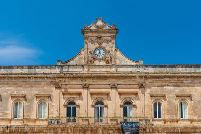 Low angle view of historical building against blue sky