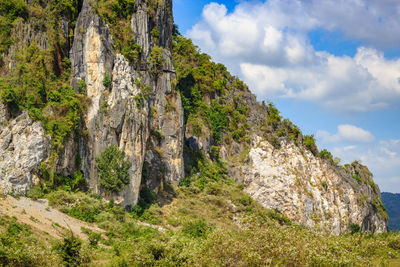 Low angle view of rocks on mountain against sky