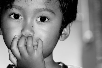 Close-up portrait of cute boy at home