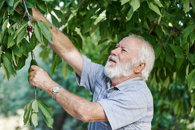 Full length portrait of man with tree