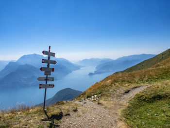 Trail signs on a path in the alps of lake como