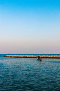 Scenic view of sea against clear blue sky