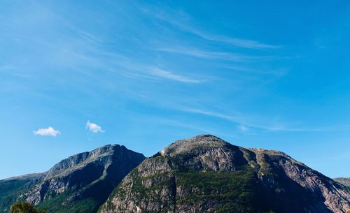 Low angle view of mountain against blue sky