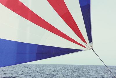 Colorful fabric on sailboat at sea 