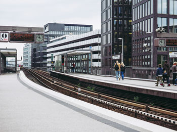 Railroad tracks by buildings in city