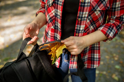 Midsection of man holding umbrella