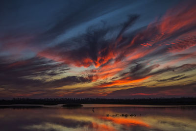 Scenic view of lake at sunset