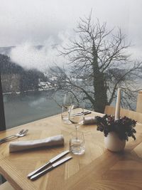 Flower vase on table against sky